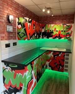 A new kitchen installation featuring green LED lighting and graffiti inspired kitchen cabinets and cupboards.