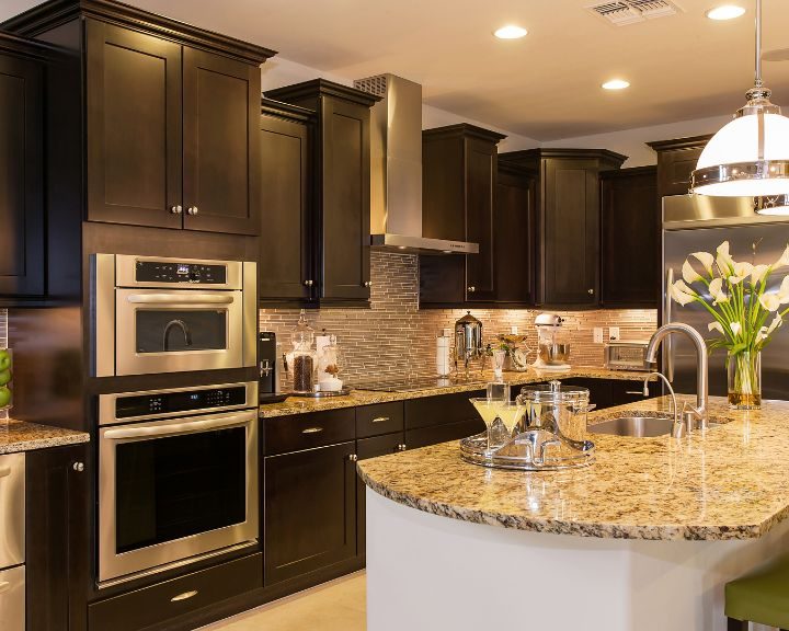 A kitchen in Basingstoke featuring dark brown cabinets and granite counter tops.