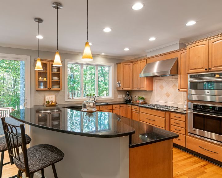 Kitchen Design A urban kitchen design featuring wooden cabinets and black counter tops.