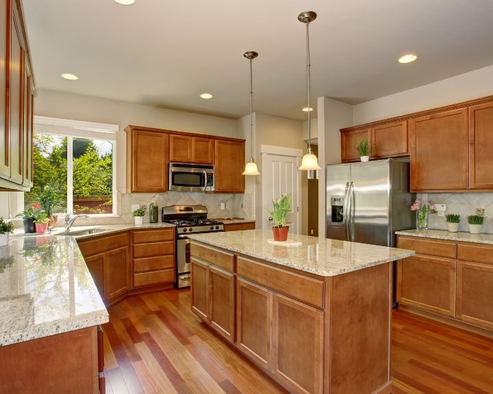 A kitchen with granite counter tops.