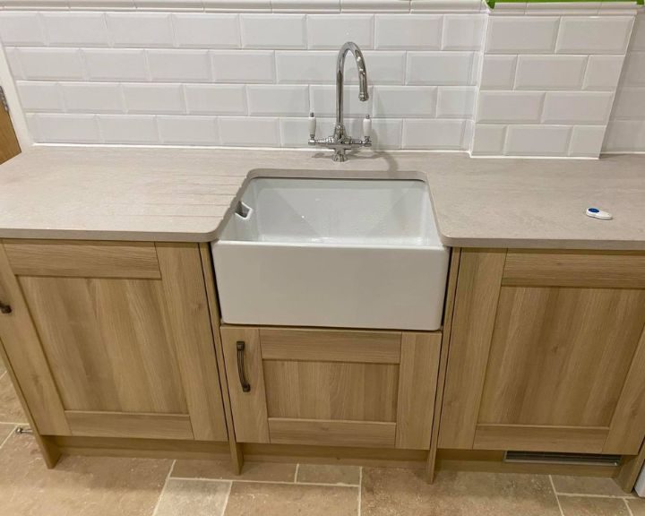 New cream marble kitchen worktops installed on some wooden cabinets.